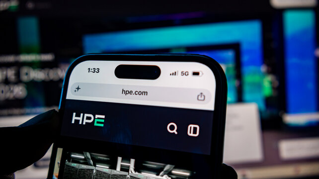 Official hpe web page on smartphone screen with tech background.