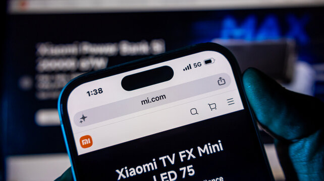 Smartphone showing xiaomi website on mobile screen in hand.