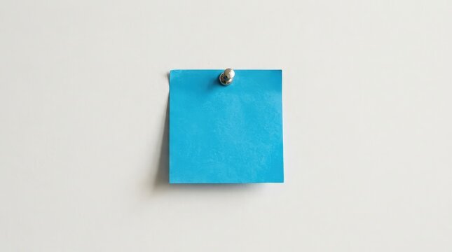 A single bright blue square sticky note attached to a plain white wall surface providing space for writing important messages or reminders