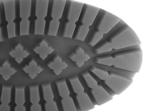 Close up of a Durable Sole for Hiking Boots, Showing Detailed Texture. macro shot showing the brown rubber shoe sole with deep, angular tread and distinctive pattern. 