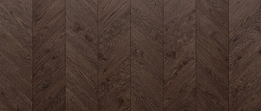 Dark brown oak wood parquet texture background in a classic chevron pattern