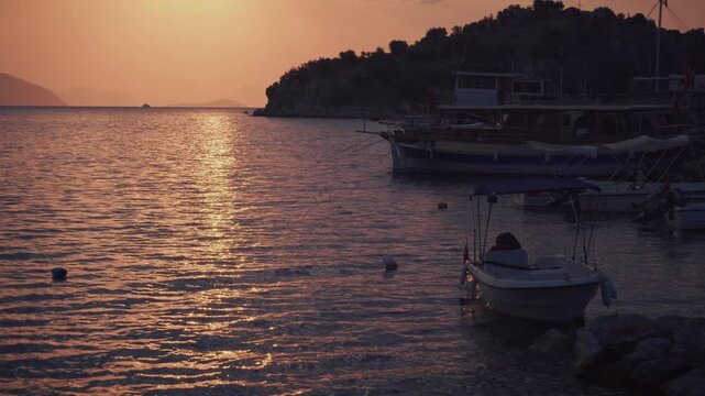 Boats Moored In Harbor At Sunset. Scenic Mountain Coastline. Calm Evening Bay Marine