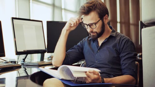 Thoughtful Businessman Reading Documents. Workplace Focused Professional Analyzing Paperwork. Information Analysis