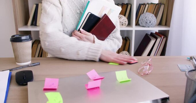 Office paperwork. Business lifestyle. Unrecognizable female professional preparing for work at desk with notebook laptop at workplace.