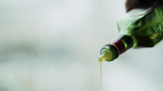 Pouring Extra Virgin Olive Oil From Glass Bottle. Ingredient Healthy