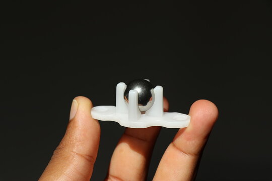 Metal ball caster wheel with plastic body for small robotics project held in the hand