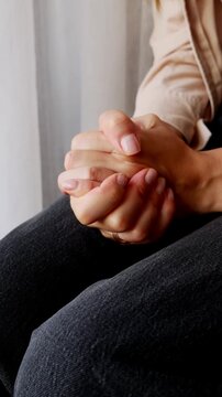 Nervous woman fidgeting with hands during therapy session for anxiety, PTSD, trauma and mental health.