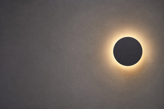 Modern Eclipse Wall Lamp Casting a Warm Halo