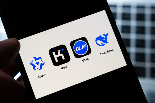 Warsaw, Poland - July 26, 2026: Chinese AI apps Qwen, Kimi, GLM and DeepSeek displayed on smartphone screen held in hand against dark background