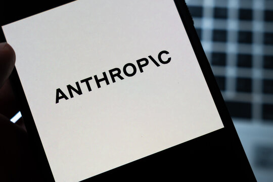Warsaw, Poland - July 26, 2026: Anthropic company logo displayed on smartphone screen held in hand against dark blurred background, representing AI technology brand