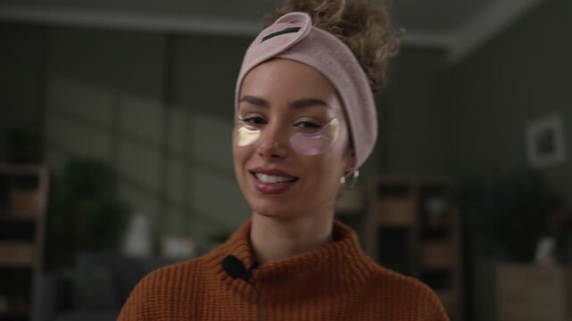 Influencer creating beauty content with under eye patches and jade roller