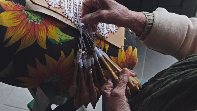Bobbin lace. A traditional lacemaker creates lace using a traditional process introduced by Azorean settlers; a handicraft available for sale in the historic center of Florianópolis 4k