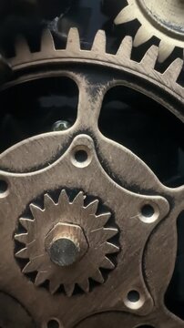 Close up of rotating brass gears in a mechanical clock mechanism