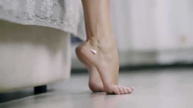 Applying Moisturizing Cream On Barefoot Foot Heel Skincare. Body Care. Hydrating Lotion 