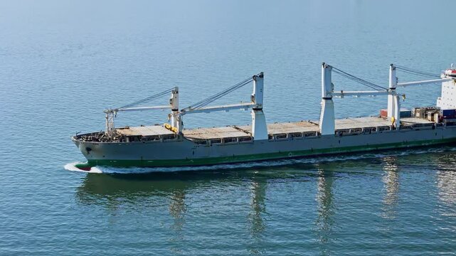 Aerial view of bulk dry cargo carrier ship. Maritime freight transport scene for logistics systems, supply flow and distribution operations
