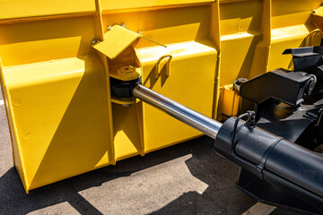 Yellow wheel loader heavy duty dozer blade mechanism. Modern construction machinery steel snow plow push frame section with hydraulic cylinder tilt and industrial vehicle engineering details. © NastyaPhoto