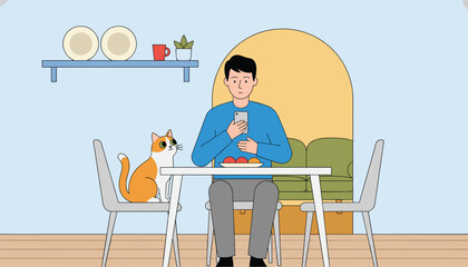 Fototapeta premium Man sitting at a dining table holding his mobile phone while a ginger cat sits on a chair next to him in the room.