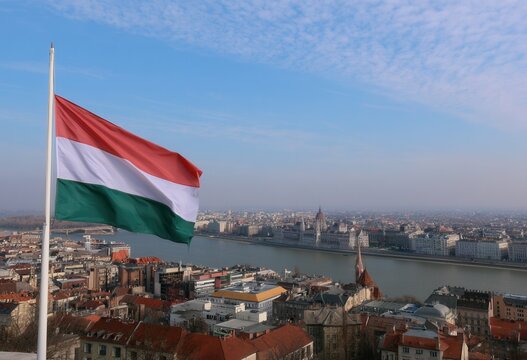 View of Budapest with hungarian flag waving under blue sky