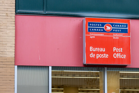 Canada, Montreal, 22 December 2025 : Canada Post Office sign on building exterior with windows