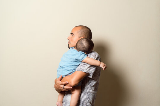 Caring parent nurturing young baby at home