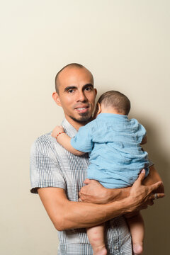 Father holding young baby celebrating new life