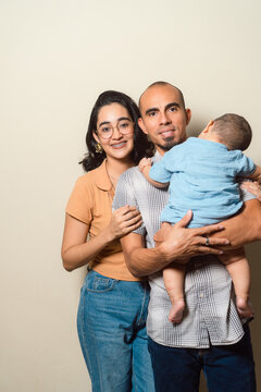 Family moment with parents holding baby during family life