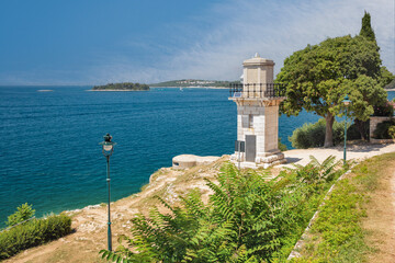 Scenic coastal view with historic lighthouse in Rovinj, Croatia. © Panama