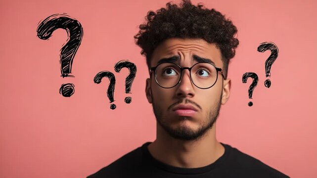 Confused young man thinking with animated question marks, looking for a solution, showing doubt and indecision while pondering a difficult problem against a pink background