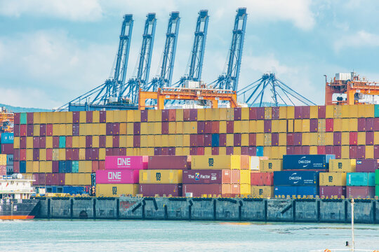 Shenzhen, China - May 22, 2026: Shipping containers stacked at Shenzhen Port with cargo cranes in background. Containerized freight, international shipping, trade infrastructure