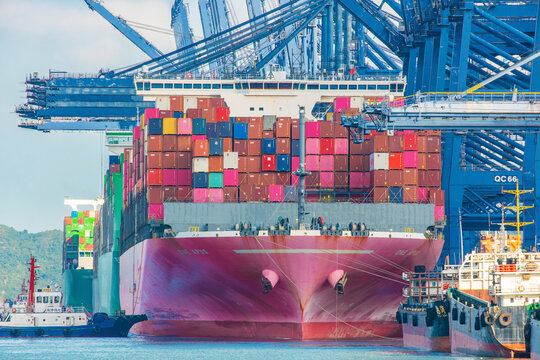 Shenzhen, China - May 22, 2026: Fully loaded container ship moored at Shenzhen Port beneath ship-to-shore cranes. Maritime logistics, container transportation, global trade, cargo handling