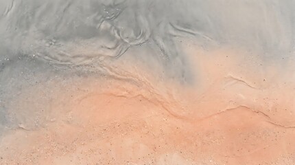 Fototapeta premium A close up view of a rough textured surface featuring a blend of grey and orange tones