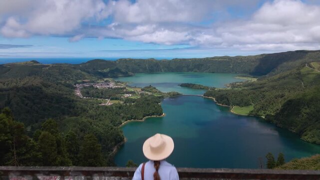 Woman walking on roof reveal view of Sete Cidades lakes