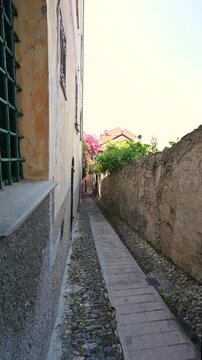 Cervo, liguria, italy. June 22, 2025. Empty narrow alleyway with stone walls and cobblestone pavement in the ancient village of cervo, liguria, one of italy's most beautiful towns