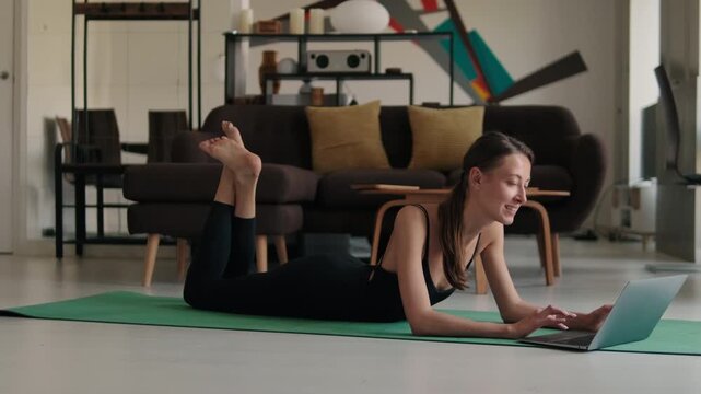 Woman on Yoga Mat Using Laptop