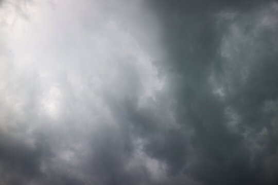 This photo shows a sky that looks cloudy, filled with thick and dense dark gray clouds typical of stratus or cumulonimbus clouds which indicate that it will rain.