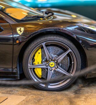 Gothenburg, Sweden - May 30 2026: Ferrari side badge and performance wheel on black supercar.