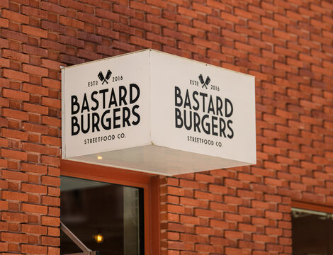 M?lndal, Sweden - June 06 2026: Generic street food restaurant sign mounted on red brick facade.