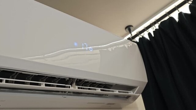 Home air conditioner shows settings on display in room