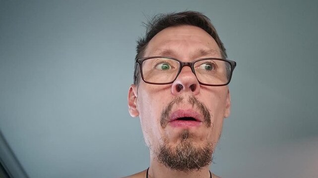 Funny man's puzzled expressions in a bright room during a strange moment