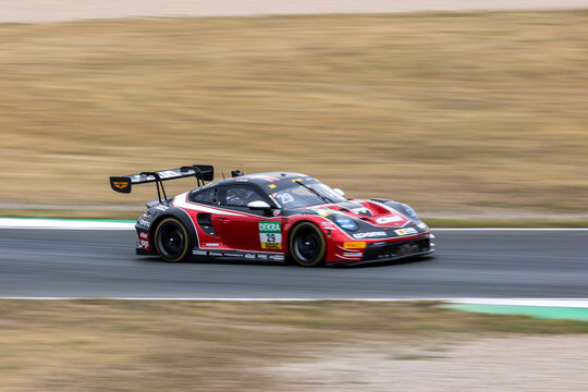 Oschersleben, Germany. 26th July 2026. Bastian Buus accelerates through Oschersleben in red, black and white number 29 Land-Motorsport Porsche 911 GT3 R Evo. Smooth panning motion isolates 