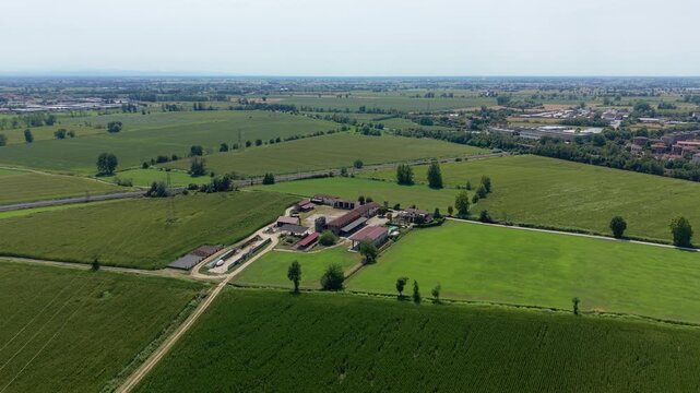 Rural Farm Landscape: An aerial view showcases a sprawling agricultural estate nestled amidst verdant fields and rolling countryside. Tavazzano con Villavesco, Lodi, Italy