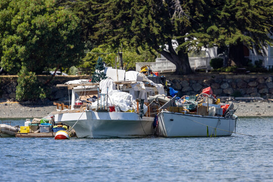 Cluttered Houseboat Packed With Gear and Supplies Moored Near Shore in Sidney, Vancouver Island BC Canada