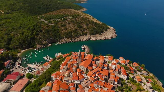 Drone shot of red tiled roofs and stone houses in historic Vrbnik town