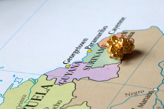 Gold Nugget on Map of Suriname Symbolizing Gold Mining and Natural Resources