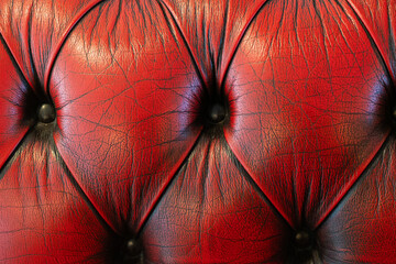 Obraz premium Close-up of classic tufted red leather furniture with button tufting