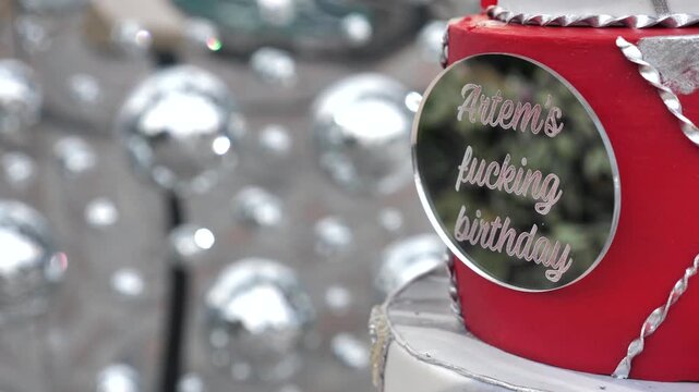 Close up of birthday cake with funny topper at party. Copy space, place for text