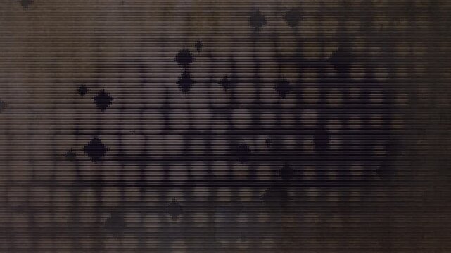 Moody grungy animation with scattered pixelated  diamond and circle shapes in beige and brown tones with a semi symmetrical layout and vintage flicker
