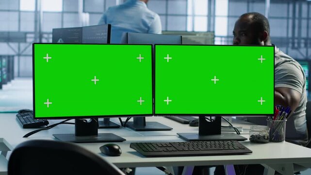 Data center green screen PC multi monitor setup in server hub workspace while highlighting data protection, network security and infrastructure risk.