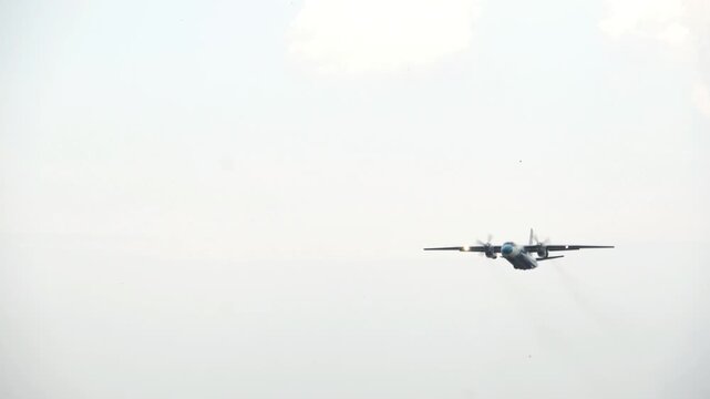 Airplane passenger liner moving on runway taking off into blue sky with forest background in 4K Ultra HD footage
