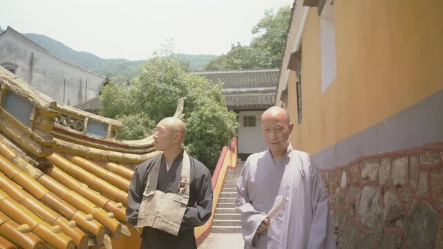 Two Buddhist monks walking and talking together in an ancient Chinese monastery